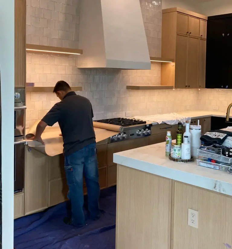 A professional general contractor reviewing architectural blueprints in a luxury Jupiter home.